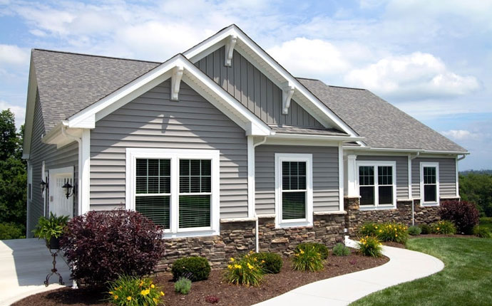 Professional siding installation in Brewer on a residential home, showing new vinyl siding