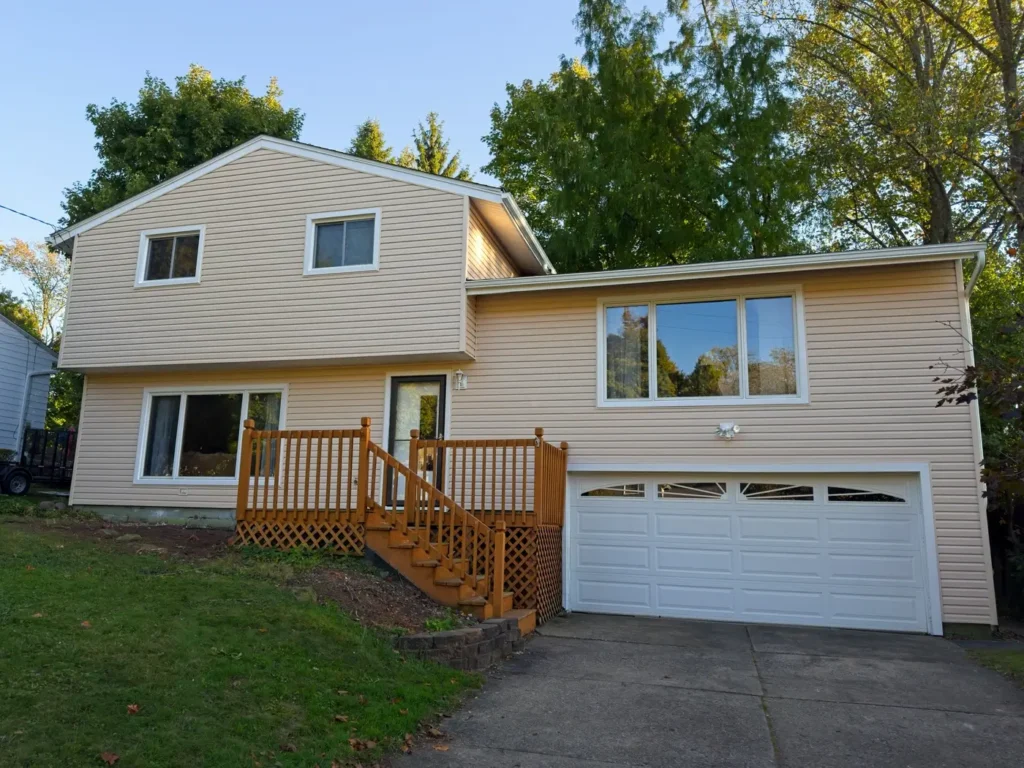 Professional siding installation in Brewer on a residential home, showing new vinyl siding